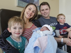 Ryan Park, born at 1:24 a.m. on New Year’s Day, makes it a family of five as the Park family — Harrison, 4, parents Emily and Michael and 18-month-old Ben — is seen in the sunroom of Kidd 5 at Kingston General Hospital on Monday, Jan. 1, 2018. (Julia McKay, The Whig-Standard, Postmedia Network)