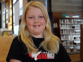 Joe Farmer shows off his golden locks at the Kingston Frontenac Public Library’s Calvin Park Branch on Saturday. Farmer has been growing out his hair for two years and will get it cut for Wigs for Kids on Wednesday. (Steph Crosier/The Whig-Standard/Postmedia Network)