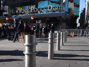 New York Mayor Bill de Blasio(C) makes an announcement during a press conference in Times Square on January 2, 2018 about new barriers to prevent terror attacks and safeguard sidewalks and plazas from vehicles. TIMOTHY A. CLARY/AFP/Getty Images