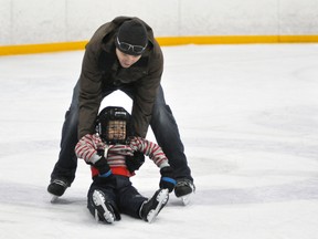 Mason Roadknight, 4, enjoyed the tour of the ice rink by dad Gord last Wednesday, Aug. 27 – one of many full or partial families to partake in the skating over the Christmas school break courtesy of various community sponsors. ANDY BADER/MITCHELL ADVOCATE