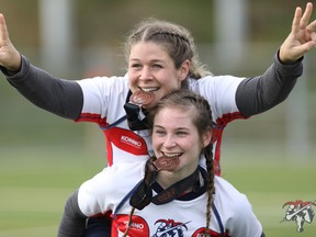 Rachelle Malette (top) and Kierstyn Bennett celebrate the first-ever medal (bronze) for the Loyalist Lancers women's rugby program at the 2017 OCAA women's rugby Sevens finals. (Sasha Sefter photo)