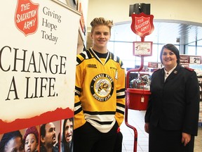 The Salvation Army raised more than $146,000 through its recent Christmas Red Kettle Campaign in Sarnia-Lambton. Pictured at the campaign launch in November are Sarnia Sting centreman Drake Rymsha and Salvation Army Capt. Nancy Braye. Sting players and others helped man nine kettle locations in Sarnia and Corunna. (Tyler Kula/Sarnia Observer/Postmedia Network)
