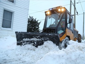 JASON MILLER/THE INTELLIGENCER
Sidewalk plow operator, Barry Tebow, clears snow from sidewalks on Meyers Street on Wednesday.