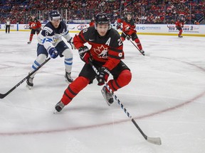 Canada's Victor Mete skates against Finland's Janne Kuokkanen during the second period of IIHF World Junior Championship preliminary round hockey action in Buffalo, N.Y. Tuesday December 26, 2017. (THE CANADIAN PRESS)
