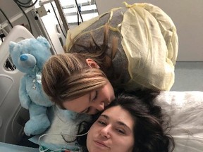 The sister of a young Quebec woman who had her limbs amputated after being electrocuted when her car struck an electrical pole in western Quebec has set up a fundraising campaign. Samantha Mongeon, left, kisses her sister Sabryna in this undated handout photo.
Samantha Mongeon / THE CANADIAN PRESS