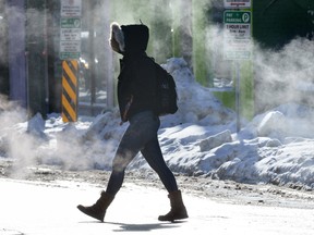 A pedestrian crosses Clarence Street at King Street in London, Ontario in the extreme cold temperatures on Thursday, January 4, 2018. (MORRIS LAMONT, The London Free Press)