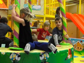 From left, Leah Jarrett, Masox Coxon's socks, Cam Coxon, and Van Robinson play in the indoor playground area at Railway City Recreation in St. Thomas, Ontario. The indoor centre is the project of two local parents who saw a need in the community. (Louis Pin/Times-Journal)