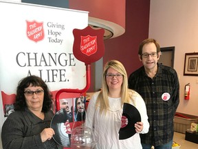 Volunteer Maria Fulford and The Salvation Army Kettle Coordinator Kendall Irvin holding a broken record with volunteer Robert McFarlane celebrating this years’ kettle total. (Contributed photo)