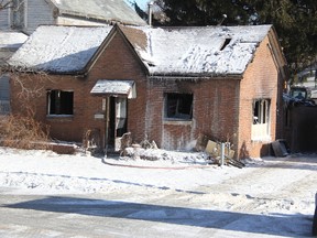 Heavy equipment at the back of a fire-damaged house demolishes the structure Thursday. Sarnia firefighters are still investigating the cause of the blaze that topped $125,000 in damage. (Tyler Kula/ The Observer)