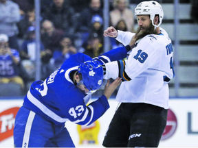 Toronto Maple Leafs centre Nazem Kadri, a London native, and San Jose Sharks star Joe Thornton, of St. Thomas, drop the gloves right off the opening face-off during the first period in Toronto on Thursday.  Kadri accidentally pulled off a piece of Thornton’s large beard. Jack Boland/Toronto Sun/Postmedia Network