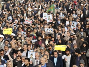 Iranian pro-government protesters take part in a march held after the weekly Friday prayers in central Tehran on January 5, 2018.
New pro-regime protests were held in Iran, in reaction to the protests against the government and the cost of living. / AFP PHOTO / ATTA KENAREATTA KENARE/AFP/Getty Images
