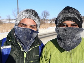 Laurentian University students Sahil Dhiman, left, and Risky Ghuman braved the cold temperatures in Sudbury, Ont. on Thursday January 4, 2018 and walked to the university. Environment Canada said Greater Sudbury will be mainly sunny but it will remain cold on Friday with a high of -23 C and a wind chill of -41 C. John Lappa/Sudbury Star/Postmedia Network