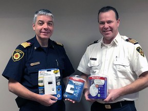 Perth East and West Perth fire Chief Bill Hunter, left, and fire prevention officer Todd McKone hold smoke and carbon-monoxide alarms on Friday, Jan. 5, 2018. The chief is urging residents to update alarms and batteries after a recent rash of false-alarm calls. (Handout)