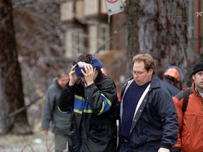 Dave Shortt, then a 23-year-old Queen's University student, holds his head after being hit on the head by an icy branch during the first day of the 1998 ice storm in Kingston on Jan. 8, 1998. (Ian MacAlpine/The Whig-Standard)