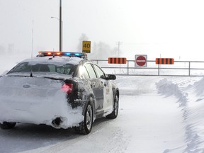 An OPP cruiser blocks the westbound on-ramp of Highway 402 on Centre Street north of Strathroy Friday as the 402 was closed for a second day. (MIKE HENSEN, The London Free Press)