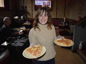 Cat Ring gets ready to serve New Haven thin-crust style pizza at Piece Brewery and Pizzeria, one of the stops on the 3-1-Chew food tour in Chicago?s Bucktown and Wicker Park neighbourhoods. Thin crust outsells deep dish in Chicago, Ring says. (WAYNE NEWTON, Special to The London Free Press)