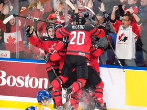Canada players celebrate forward Tyler Steenbergen's goal against Sweden during the third period of the gold-medal game at the IIHF World Junior Championship in Buffalo, N.Y. on Friday, January 5, 2018. (THE CANADIAN PRESS/Frank Gunn)