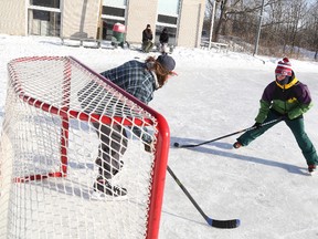 Max Proulx goes for goal against his friend Josh Turner during there shinny game at the Batawa Lions Rinks.