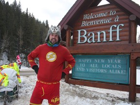 Jamie McDonald, of Gloucester, Eng., stands in front of the Welcome to Banff sign as he enters the community on New Year's Eve in 2013. The long-distance walker recently paid a visit -- by car -- to Sudbury to promote a book based on his 2013 trip across the country. (Dave Husdal/Postmedia)