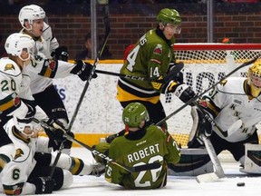 London Knights goalie Jordan Kooy deals with North Bay Battalion fourth-liners Kurtis Evans (14) and Alex Robert (26) as teammates Andrew Perrott (24), Sergey Popov (20) and Riley Coome (6) watch during the third period of OHL action at Memorial Gardens, North Bay, Sunday. London rallied from a 4-1 deficit to make it 5-3 and pulled Kooy for most of four minutes but the home-side scored into an empty net for a 6-3 win. (Dave Dale / The Nugget)