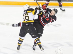 Kingston Frontenacs’ Ted Nichol, left, collides with Niagara IceDogs’ Kyle Langdon during first-period Ontario Hockey League action Sunday afternoon at Meridian Centre in St. Catharines. (Colin Dewar/For Postmedia Network)