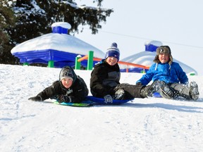 Enjoying the last few days of their Christmas school break last Thursday, Jan. 4, Logan Nugent (left), 12; Lawson Vandenbrink, 13 and Andreas Harmer, 12 spent a fair amount of time sliding over a ramp at the popular swimming pool hill. ANDY BADER/MITCHELL ADVOCATE