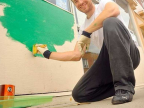 In a 2015 file photo, Tillsonburg town councillor Max Adam paints the front of his Simcoe bar, the Kilnyard. Adam is facing three criminal charges stemming from an incident outside the business on New Year's Eve.