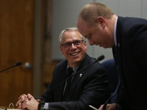 Jason Miller/The Intelligencer 
Coun. Jack Miller (left) shares  laugh with Coun. Paul Carr at Monday's council meeting. Miller, transit chair, announced that transit ridership was up nine per cent in 2017.