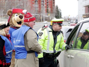 Members of the Greater Sudbury Police Service Traffic Management Unit, in partnership with Safe Ride Home Sudbury,  launch the Safe Ride Home Sudbury Campaign on Nov. 16. (Gino Donato/Sudbury Star file photo)