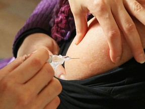 Luke Hendry/Intelligencer file photo
A public health nurse injects flu vaccine. Six long-term care or retirement homes have outbreaks of influenza or other respiratory illnesses.