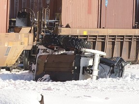 Witnesses could only watch as plow crept into path of freight at notorious crossing near Colborne and York streets Tuesday morning. (DEREK RUTTAN, The London Free Press)