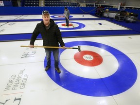 Chief ice tech Dave Merklinger looks over the ice pads being prepared for this week?s Continental Cup curling championship at the Western Fair Sports Centre in London. (MORRIS LAMONT, The London Free Press)