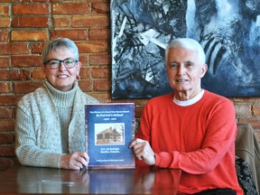 Marianne Lucio and Larry Lahey are shown with their book – The History of a One-Room School, St. Patrick's School, Merlin, ON, 1922-1968.