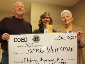 TIM MEEKS/THE INTELLIGENCER
Barb Whiteman of Belleville, centre, accepts the winning grand prize of $15,518 from the Catch the Ace Belleville progressive raffle from Belleville Lions Club member Dan Collins and Margaret Goyette, community development worker for Continuing On In Education, Wednesday. COED and the Lions Club will run Catch the Ace again this year and are hoping to start the weekly raffle in February.