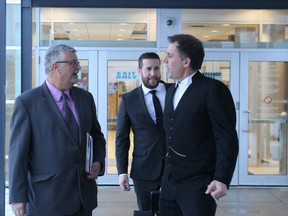 Former Sarnia fire chief Patrick Cayen, left, and his defence lawyer Phillip Millar leave the Sarnia courthouse following the first day of his second trial on sex charges. His conviction was overturned by Ontario's court of appeal. (NEIL BOWEN/Sarnia Observer)