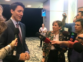 Prime Minister Justin Trudeau speaks with reporters as the federal Liberals bring their cabinet tour to London Thursday morning.