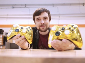 Mike Daoust, founder of the Sudbury Game Design Challenge, shows off two of the awards in Sudbury on Wednesday. Gino Donato/Sudbury Star/Postmedia Network