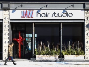 Tim Miller/The Intelligencer
A pedestrian walks past the now closed Jazz Hair Studio in downtown Trenton. The business closed its doors at the beginning of the year following the release of new employer regulations by the provincial government.