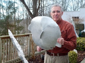 Well-known St. Thomas artist David Morris holds a sculpted janus, a two-sided head to be installed at the new elevated park before it opens this spring. Morris was the founding director of the St. Thomas-Elgin Public Art Centre in the 1970s. (Louis Pin/Times-Journal)