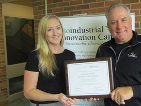 Julia Struyf, marketing and communications manager with Bioindustrial Innovation Canada, and Sandy Marshall, the agency's executive director, hold the Canadian Resource Champion award the Sarnia-based organization received from the Canadian Chamber of Commerce. (Paul Morden/Sarnia Observer)