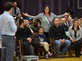Prime Minister Justin Trudeau responds to a heckler during a town hall meeting at Western University?s Alumni Hall Thursday. The woman, who was ranting about ISIS, was escorted out by security. (MORRIS LAMONT, The London Free Press)