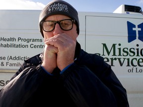 Mission Services of London employee Paul Sage warms up his fingers next to the organization’s refrigerated delivery van. Sage, a former Mission Services client, now helps deliver food to Mission Services programs across London. He’ll also be sharing his experiences when Mission Services launches a major fundraiser next week. (CHRIS MONTANINI, Londoner)