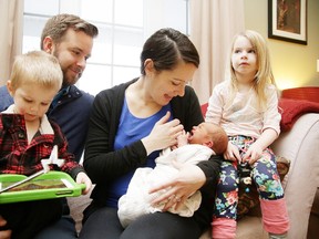 Greg and Melissa Cummings with their newborn child Breton and their children two-year-old Luke and four-year-old Ella at their home in Chelmsford, Ont. on Thursday January 11, 2018. Breton was born in the couple's vehicle on the way to Health Sciences North.Gino Donato/Sudbury Star/Postmedia Network