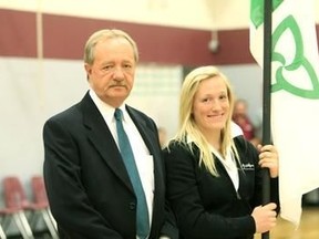 In this file 2010 photo Michel Dupuis, one of the creators of the Franco-Ontarian flag, is seen with his daughter, Natalie. Dupuis died Thursday at the age of 62.
