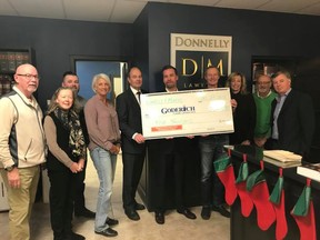 Donnelly and Murphy lawyers, Sheryl Feagan (2nd from left), Michael Donnelly, Philip Smith, and Patrick Murphy (holding cheque) present their $5,000 donation to members of the Revitalization Committee. (Contributed photo)