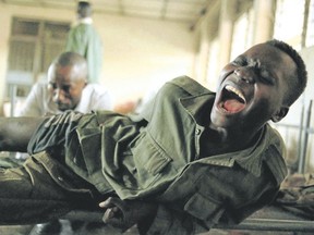 A young soldier of the Movement of the Liberation of Congo screams in pain as a doctor at a hospital in Gbadolite cleans a bullet wound in 2000. (Tyler Hicks/The New York Times)
