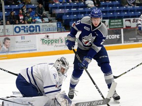 Nolan Hutcheson, right, of the Sudbury Wolves, looks for a loose puck as goalie Jacob Ingham, of the Mississauga Steelheads, covers up during OHL action at the Sudbury Community Arena in Sudbury, Ont. on Friday January 12, 2018. John Lappa/Sudbury Star/Postmedia Network