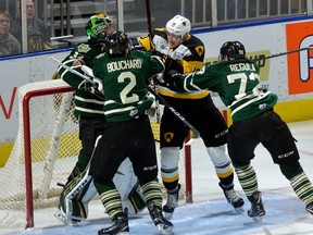 Knights defencemen Evan Bouchard and Alec Regula take a run at Hamilton Bulldog forward Nicholas Caiman after he took a whack at London goalie Joseph Raaymakers during the first period of their OHL game at Budweiser Gardens on Friday night. (MORRIS LAMONT, The London Free Press)