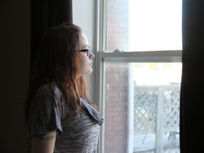 Brandi-Lee Skyring-Lepage, 19, stares out a window at her Stratford home. She was diagnosed with cystic fibrosis when she was two years old and will soon be on the waiting list for a double-lung transplant. (JONATHAN JUHA, Beacon Herald)