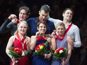 Senior pairs gold medallists Meagan Duhamel and Eric Radford, centre, silver medallists Julianne Seguin and Charlie Bilodeau, left, and bronze medallists Kirsten Moore-Towers and Michael Marinaro of Sarnia, Ont., show their medals following the 2018 Canadian figure skating championships in Vancouver on Saturday, Jan. 13, 2018. (Jonathan Hayward/The Canadian Press)